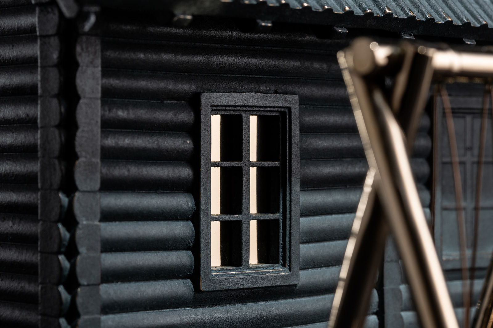 Dim — detail, the lit window behind the swing
