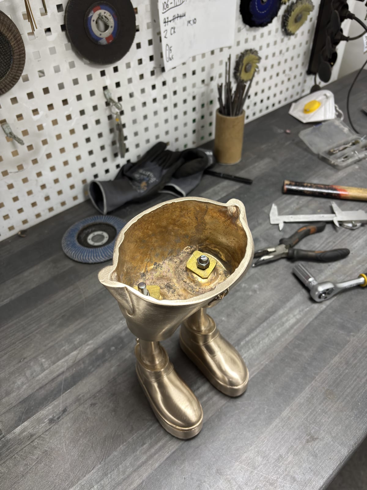 Raw bronze cast on the workbench, among the tools